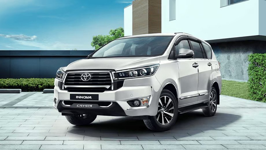 Toyota Innova Crysta Cab driving through scenic mountain pine road in Kashmir